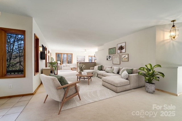 living room featuring light tile patterned floors and ceiling fan