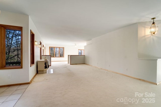 empty room featuring light colored carpet and ceiling fan