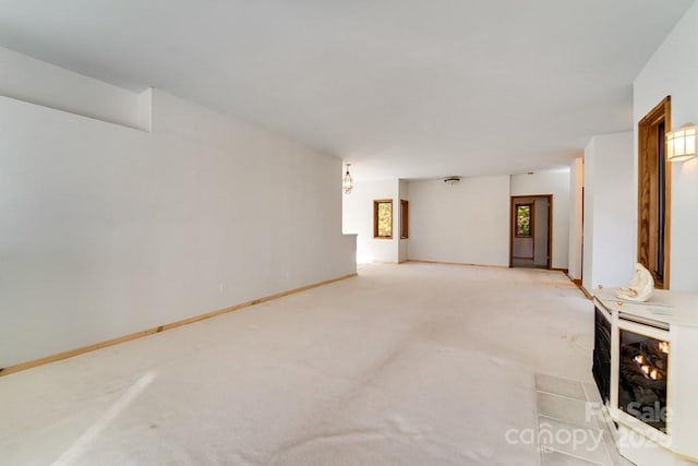 unfurnished living room featuring light colored carpet