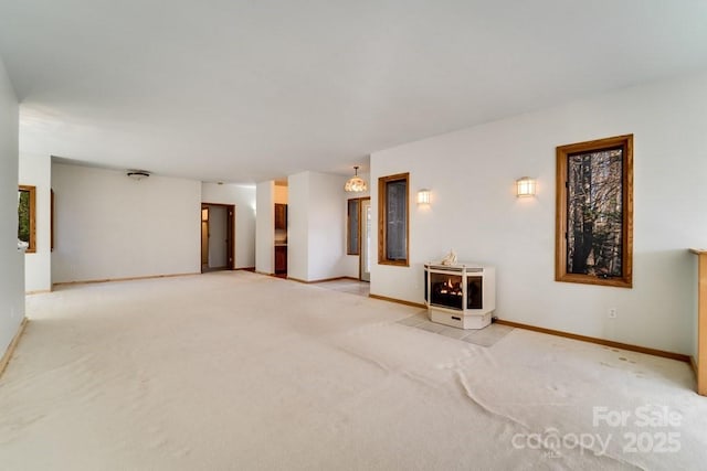 carpeted spare room with a wood stove