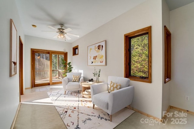 living area featuring ceiling fan