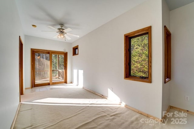 carpeted spare room with ceiling fan