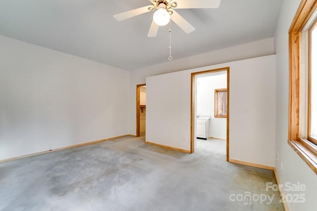 carpeted spare room with ceiling fan and plenty of natural light