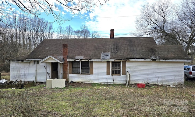 back of property featuring a lawn