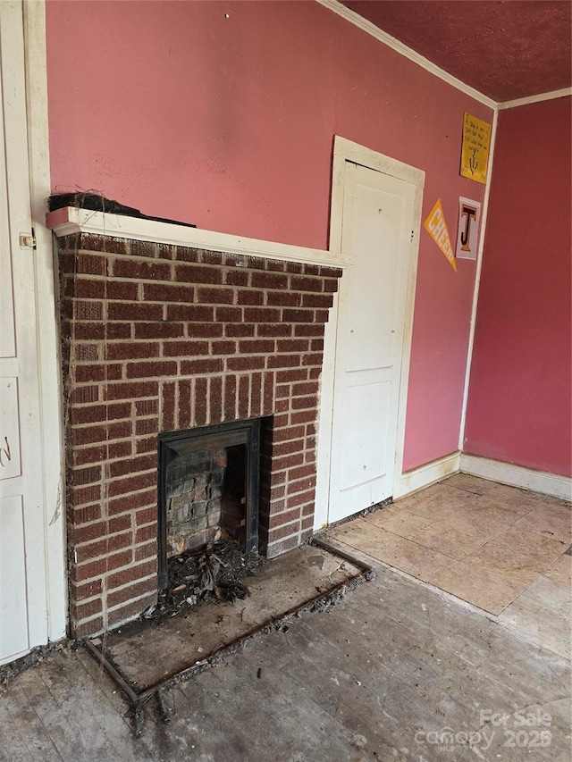 unfurnished living room featuring a fireplace and ornamental molding