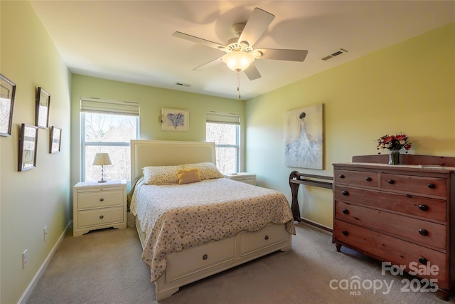 bedroom with multiple windows, light colored carpet, and ceiling fan