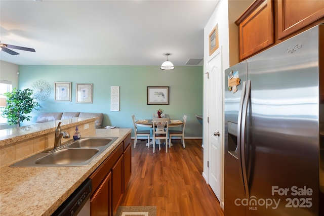 kitchen featuring appliances with stainless steel finishes, pendant lighting, sink, ceiling fan, and dark wood-type flooring