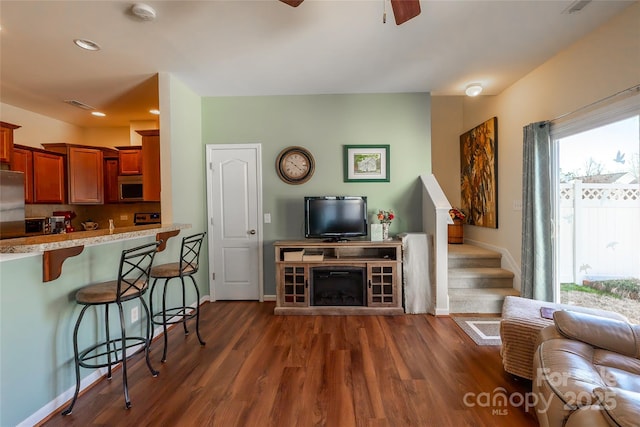 living room featuring dark hardwood / wood-style floors and ceiling fan