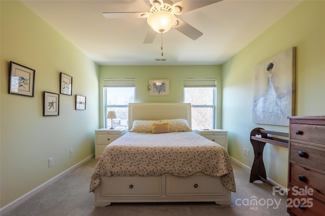 bedroom featuring multiple windows, light carpet, and ceiling fan