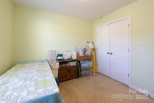 bedroom with light carpet and a closet