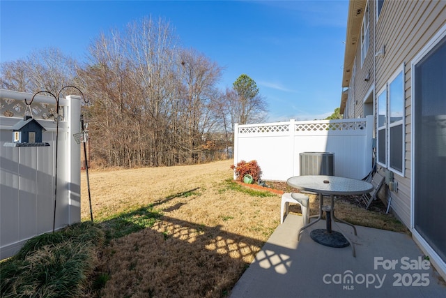 view of yard with central AC unit and a patio area