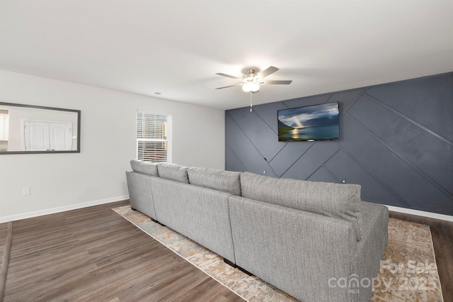 unfurnished living room with dark wood-type flooring and ceiling fan