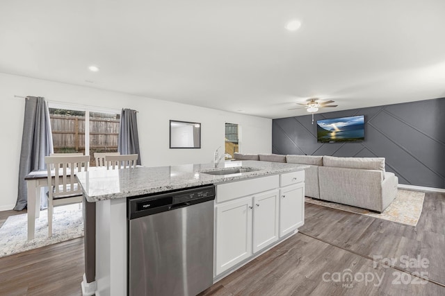 kitchen with white cabinetry, dishwasher, wood-type flooring, sink, and an island with sink