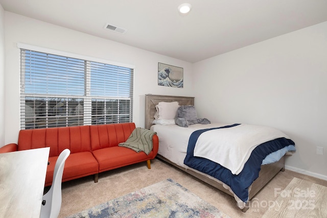 bedroom with light colored carpet