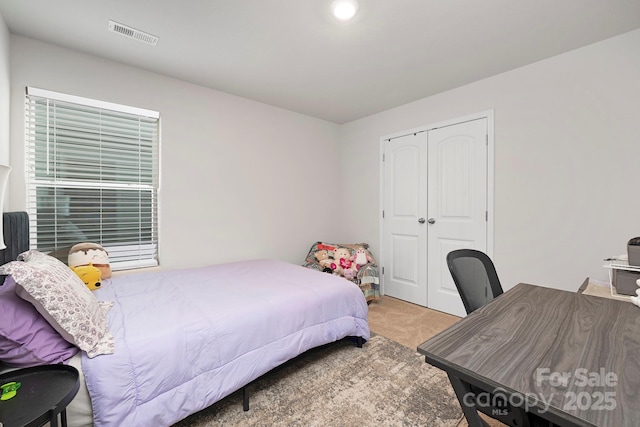 carpeted bedroom with a closet