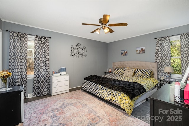 bedroom featuring ornamental molding, hardwood / wood-style floors, and ceiling fan