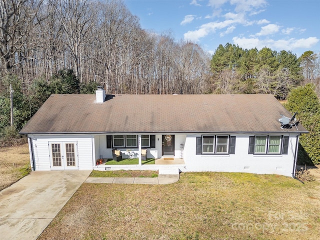 view of front of home featuring french doors and a front lawn