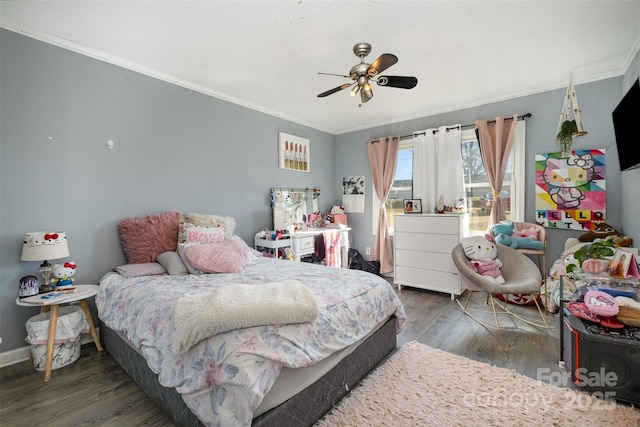 bedroom featuring ceiling fan, ornamental molding, and dark hardwood / wood-style flooring