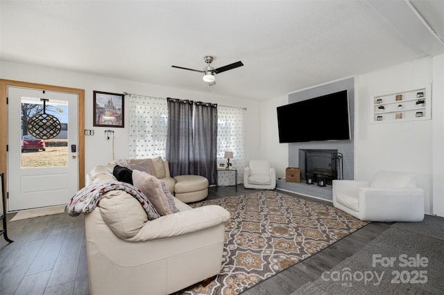 living room featuring ceiling fan, wood-type flooring, and a wealth of natural light