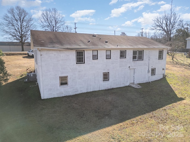 view of home's exterior featuring central AC and a yard