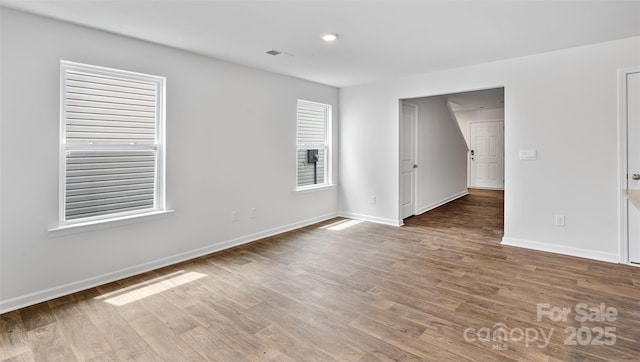 empty room with hardwood / wood-style flooring