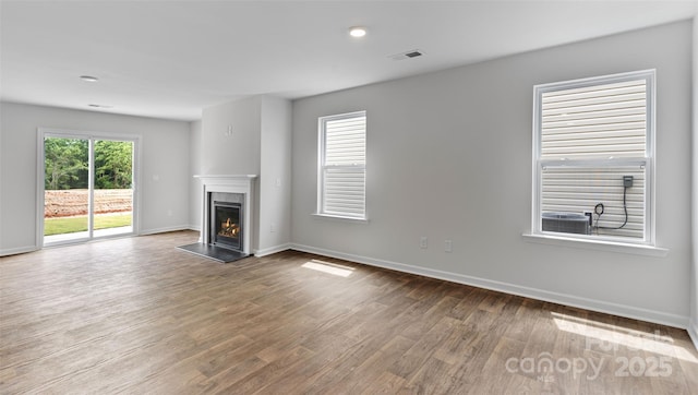 unfurnished living room featuring hardwood / wood-style floors and a fireplace