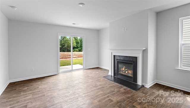 unfurnished living room with dark wood-type flooring