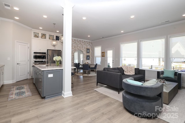 living room featuring ornamental molding and light wood-type flooring