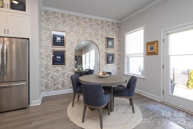 dining area featuring crown molding and hardwood / wood-style flooring