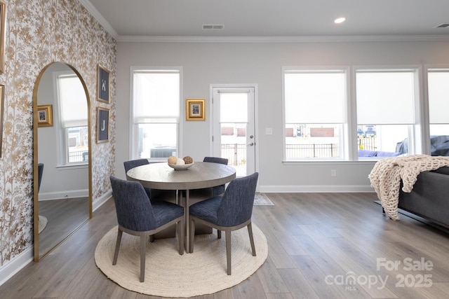 dining room featuring ornamental molding and hardwood / wood-style floors