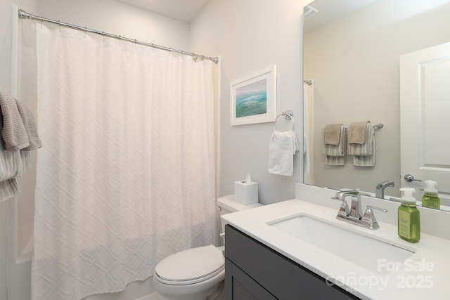 bathroom featuring vanity, walk in shower, and toilet