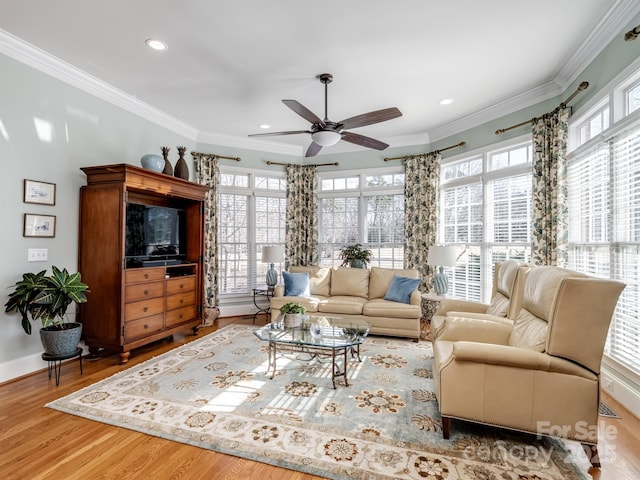 living room with crown molding, ceiling fan, and hardwood / wood-style flooring