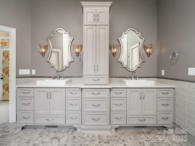 bathroom featuring vanity and tile walls