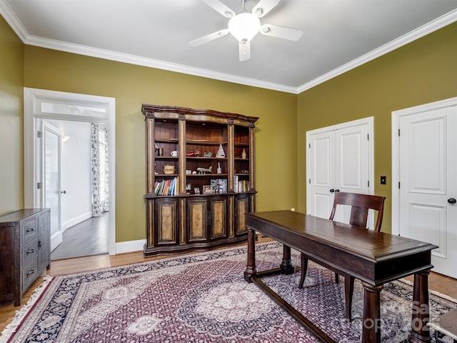 office with crown molding, light hardwood / wood-style floors, and ceiling fan