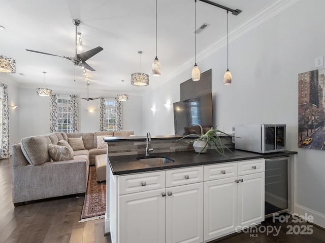 kitchen featuring ornamental molding, sink, white cabinets, and dark hardwood / wood-style flooring