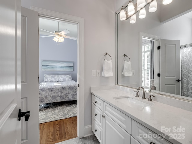 bathroom featuring vanity, wood-type flooring, and ceiling fan