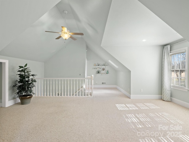 additional living space with lofted ceiling, light carpet, and ceiling fan