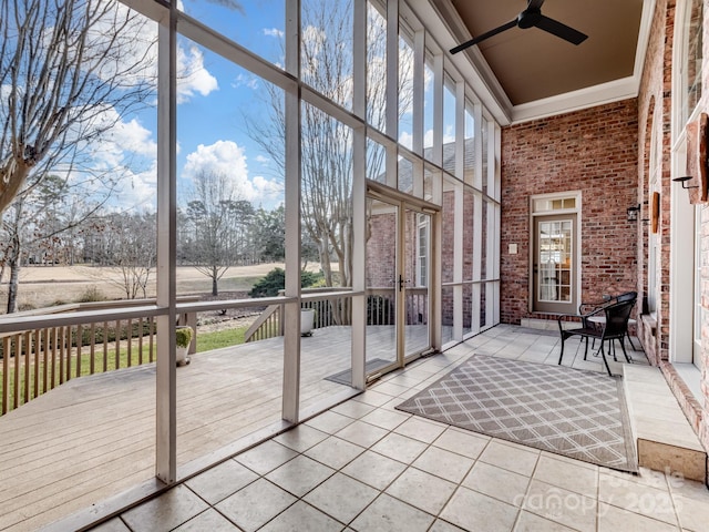 unfurnished sunroom with plenty of natural light and ceiling fan