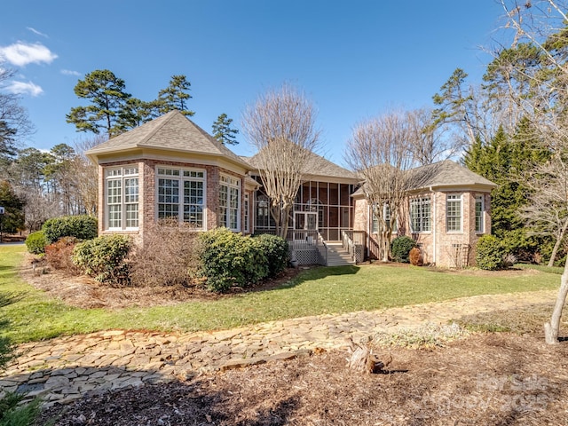 view of front of property with a front lawn and a sunroom