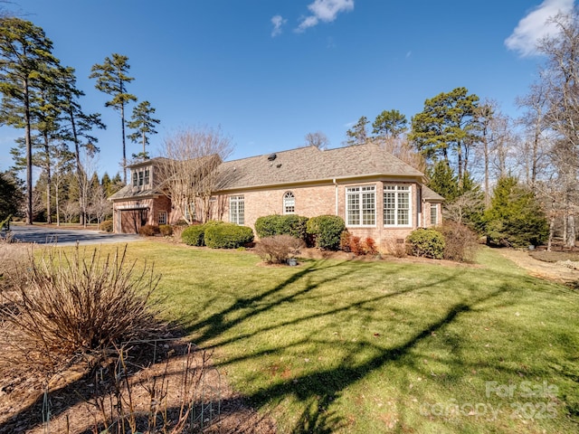 view of front of home featuring a garage and a front yard