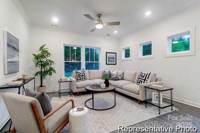 living room with crown molding, wood-type flooring, and ceiling fan