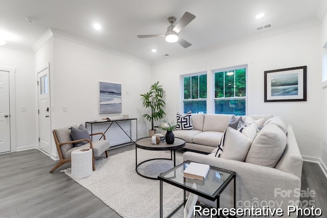 living room featuring crown molding, ceiling fan, and hardwood / wood-style floors