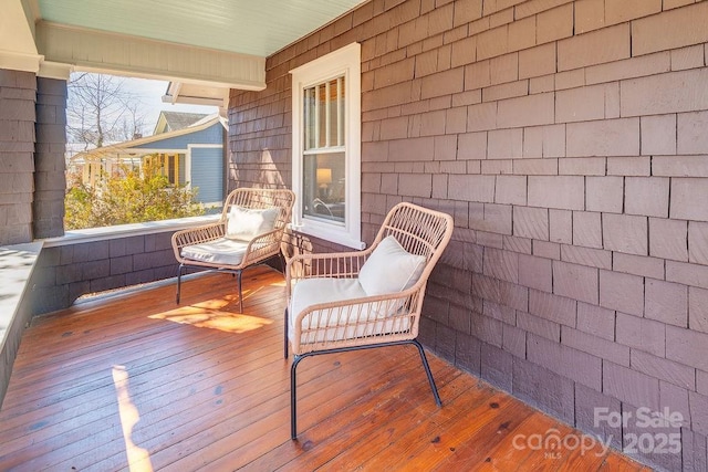 wooden terrace featuring covered porch