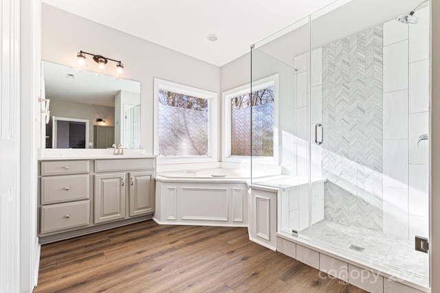 bathroom with vanity, wood-type flooring, and a shower with door