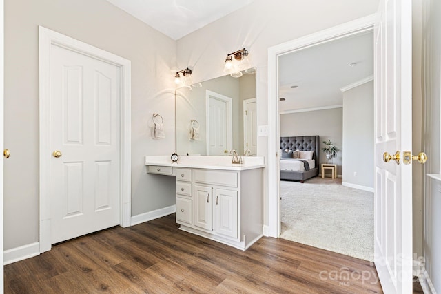 bathroom with hardwood / wood-style flooring and vanity