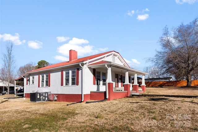 exterior space with central AC, covered porch, and a front lawn