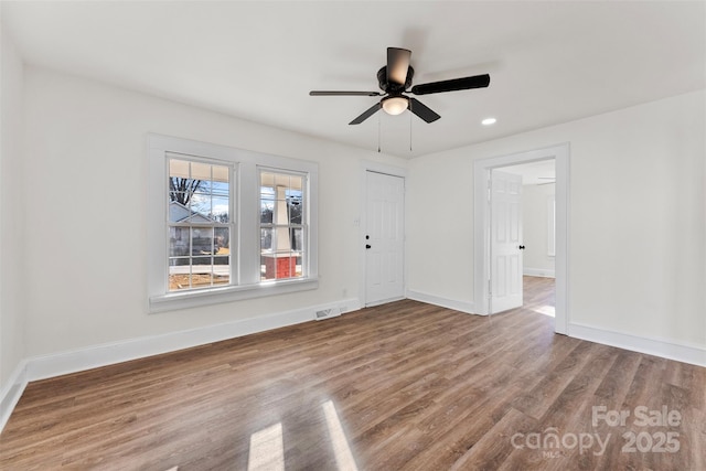 empty room with wood-type flooring and ceiling fan