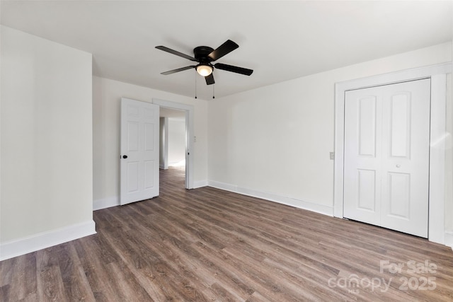 spare room with ceiling fan and dark hardwood / wood-style flooring