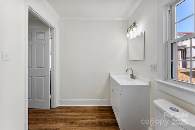 bathroom featuring vanity, crown molding, wood-type flooring, and toilet