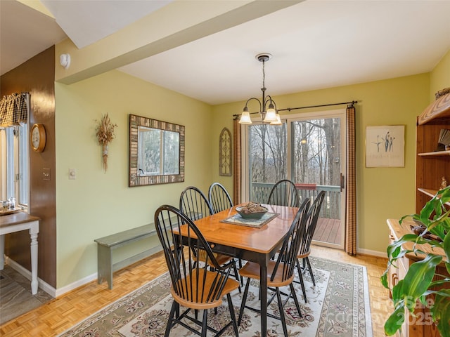 dining room featuring a chandelier and light parquet floors